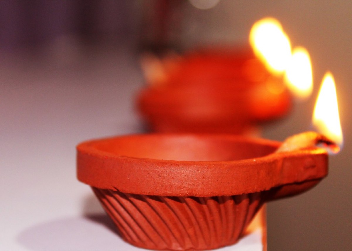A lit clay diya lamp